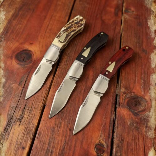 Model/Item/Part - BG042. Begg - Mini Hunter Recurve Slip Joint Knife Black/Orange Handles. 3" (7.62cm) closed. 2.13" (5.41cm) satin finish 14C28N Sandvik stainless blade. Red sandalwood and ebony and beef bone handle. Stainless bolster(s). Recurve blade. Black inlay shield. Black nylon zippered storage case. Boxed. Made in China. Specifications